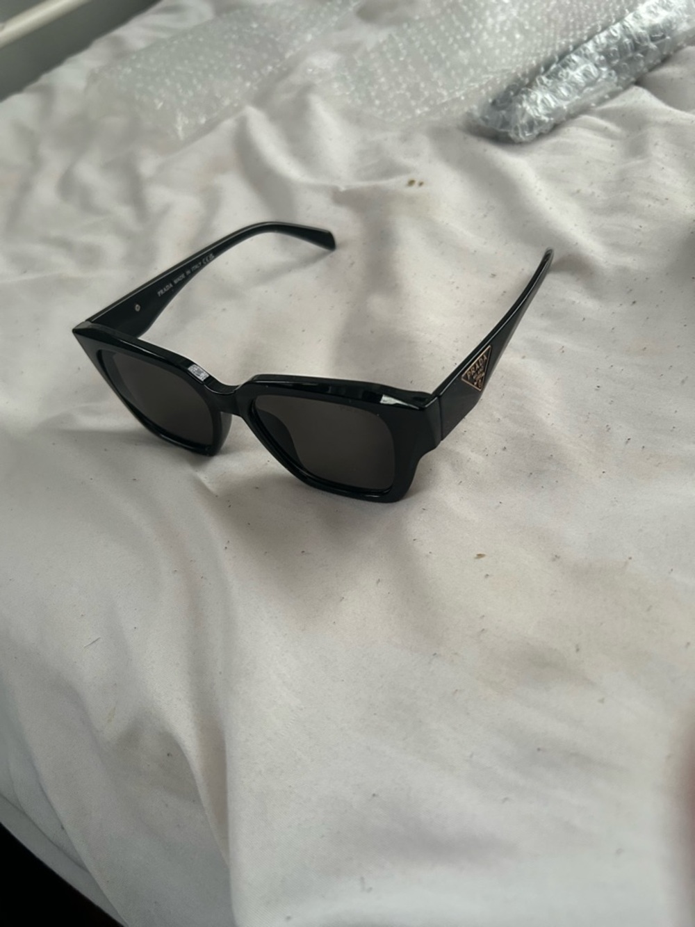 Prada Black Cat-Eye Sunglasses with Gold Logo Accent